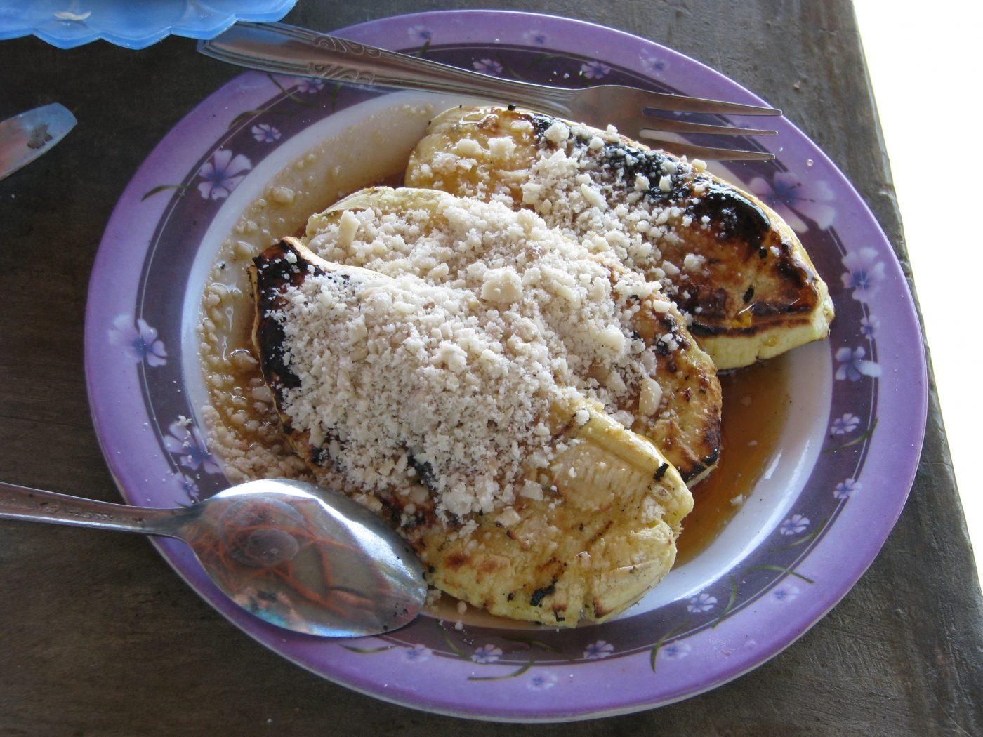 Three grilled bananas topped with chocolate and peanuts - a typical Kupang snack