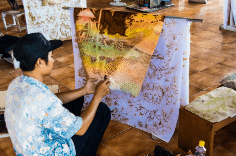 Man painting fabric doing batik in Bali