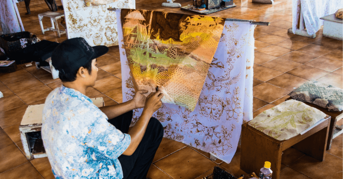 Man painting fabric doing batik in Bali