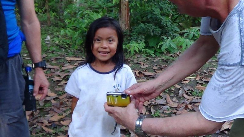 Kichwa girl approves of the picture on the camera screen