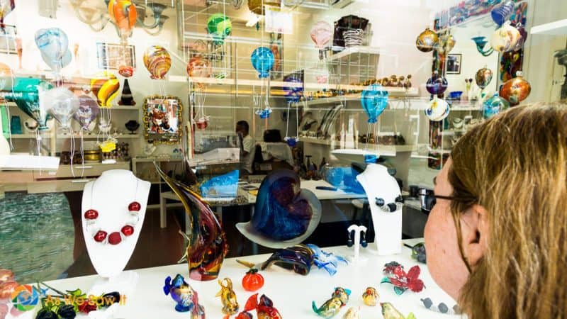 woman looking into a Murano glass shop 