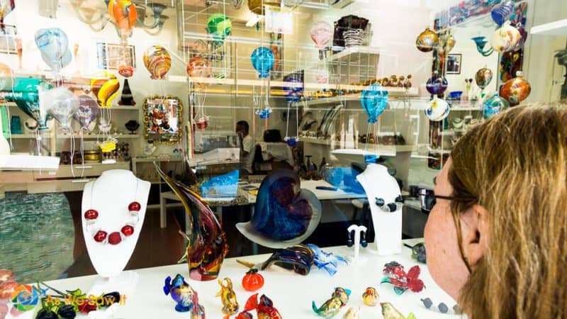 woman looking into a Murano glass shop