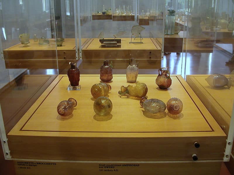 old glass objects in a display case at the Murano Glass Museum 