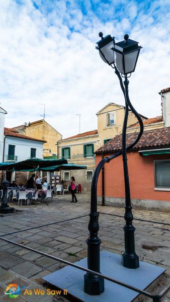 two quirky lampposts hug each other in Murano Italy