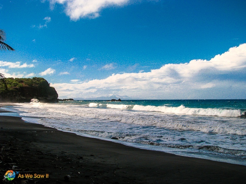 view down the black sand to the far cliffs at Hampstead Beach Dominica