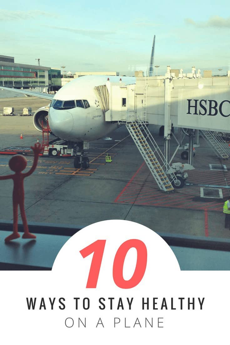 plastic figure in foreground, waving out the airport window at a plane parked and ready for passengers. Text overlay says 10 ways to stay healthy on a plane