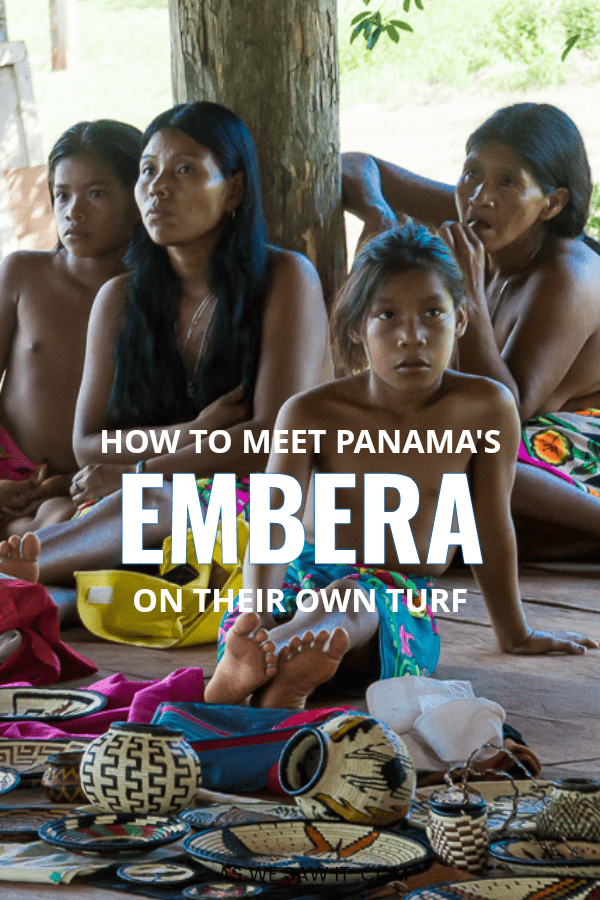 Four Embera women sit with their baskets during a tour of their village in Panama.