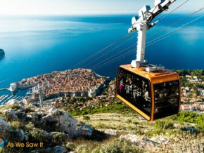 apt adriatic coastal cruise Orange cable car rises to top of Mount Srd. View of Dubrovnik and Adriatic sea in background.