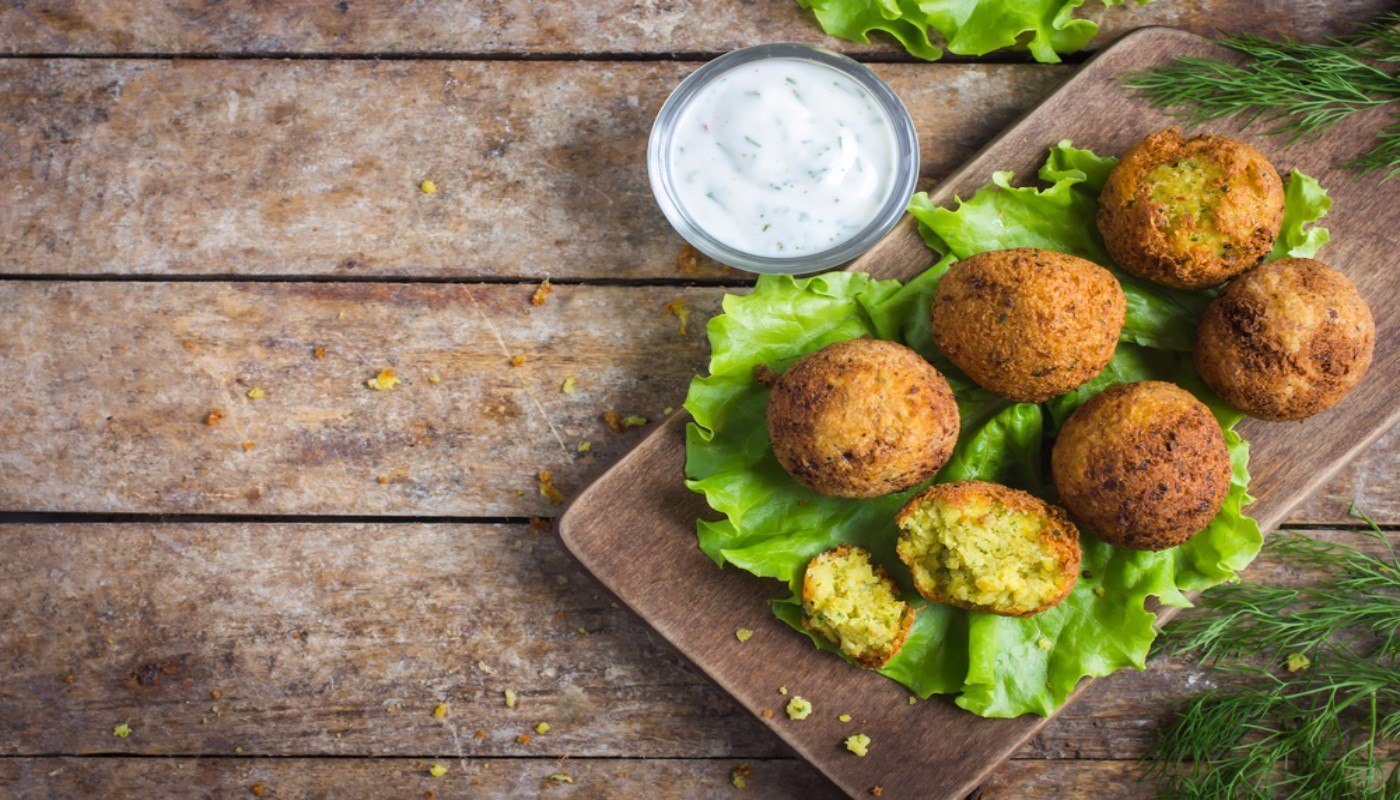 Platter of Falafel with a small side bowl of tzatziki sauce. This is a really healthy middle eastern food, made of protein-rich chickpeas