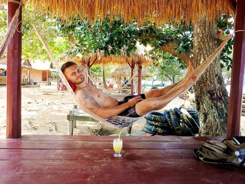 Author in a hammock with a  glass of fruit juice next to him