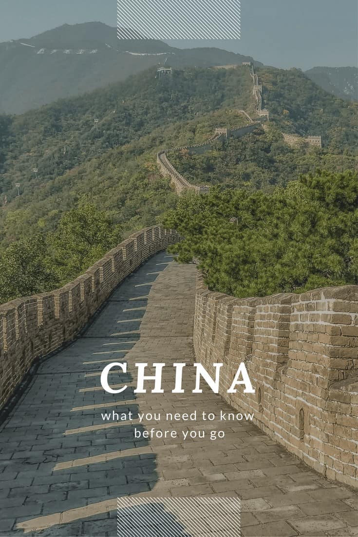 Distance view of great wall of China as seen from the walk on top. Text overlay says China what you need to know before you go.