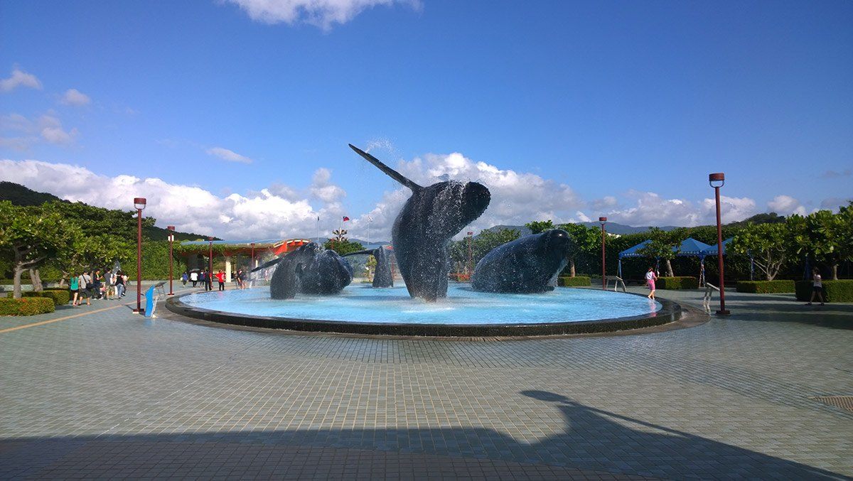 Whale sculptures appear to be jumping out of a fountain at the National Museum of Marine Biology and Aquarium