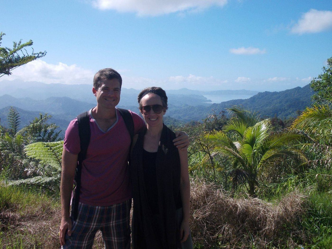 Kelli and Ryan Biddulph pose during one of their best housesitting jobs, on a tropical hill overlooking the bay in Savusavu Fiji.