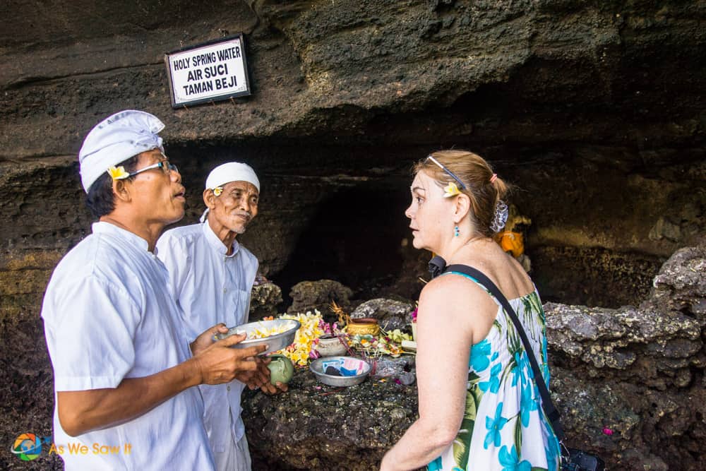 Linda talking with a priest after crossing onto Tanah Lot Temple