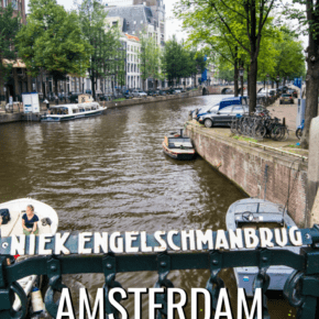bicycle parked on bridge over a boat-lined canal in amsterdam