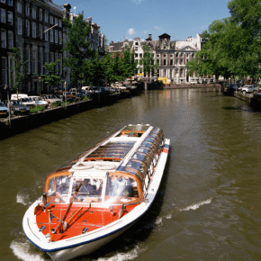 Canal tour boat text says amsterdam