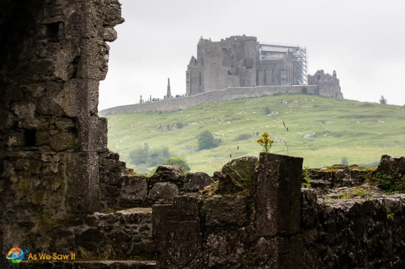 Distant view of Rock of Cashel on a hill as seen from Hore Abbey.