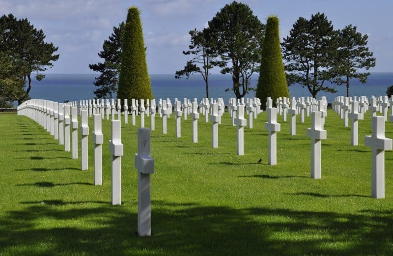 White crosses on a hill overlooking the ocean in a Normandy cemetery