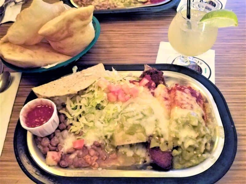 Platter of enchiladas with red and green chile sauce on them, Christmas style