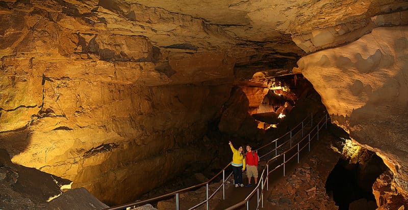 Jessie Carson and Burak Lacinier gaze at the broad vista and rocky breakdowns of Thanksgiving Hall in Mammoth Cave, near the cave's Frozen Niagara area. Thanksgiving Hall in Mammoth Cave