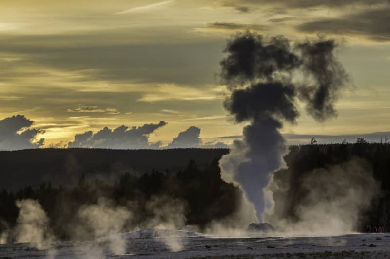 Sunset silhouettes Lion Geyser in Yellowstone