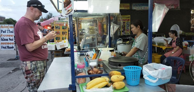 Man buying street food in Chiang Mai Thailand