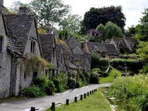 row of thatched houses in a cotswolds village