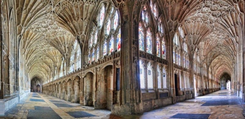 interior of Gloucester cathedral with stained glass windows and arched ceilings