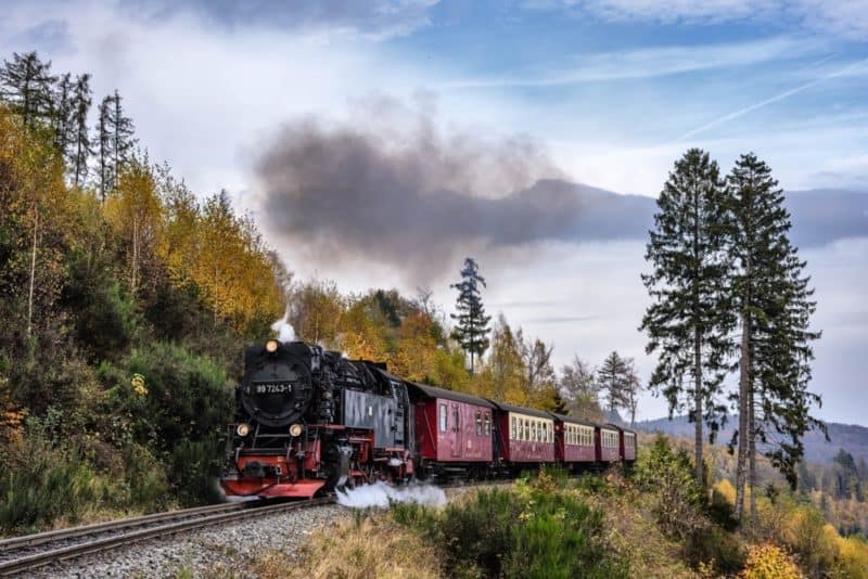 steam engine and cars, with smoke coming from the chimney