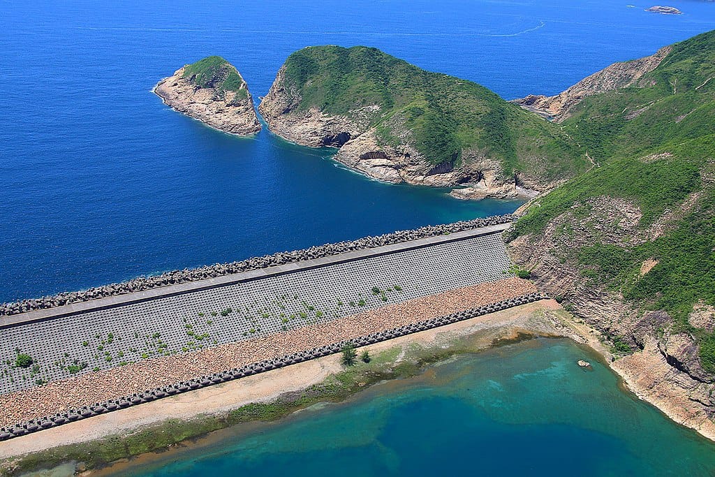 aerial view of dam with water on both sides