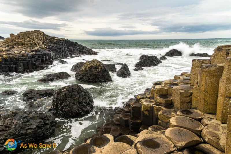 waves crashing against hexagonal rocks at Giant's Causeway