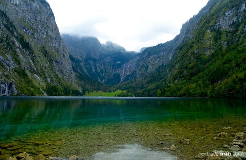 Clear mountain lake at Konigsee with mountains dropping into the water.