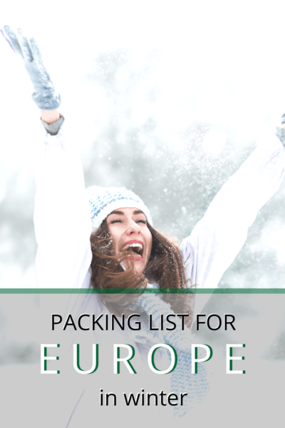 woman rejoicing in the snow with arms extended upwards text says packing list for europe in winter