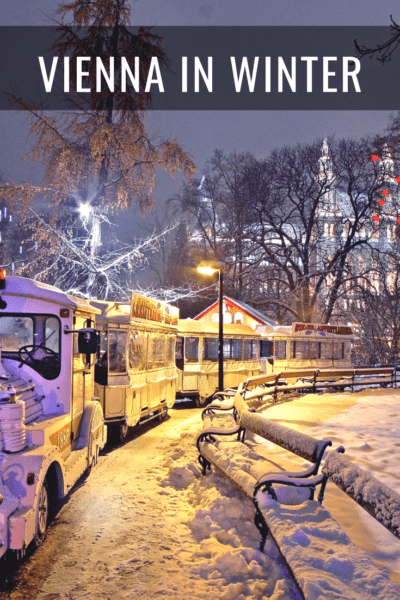 snowy night with train ride at vienna christmas market text says vienna in winter