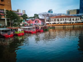 River cruise boats lined up on the singapore river at sunset