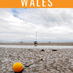 tide out at abersoch with orange bouy up close text says places to visit in wales