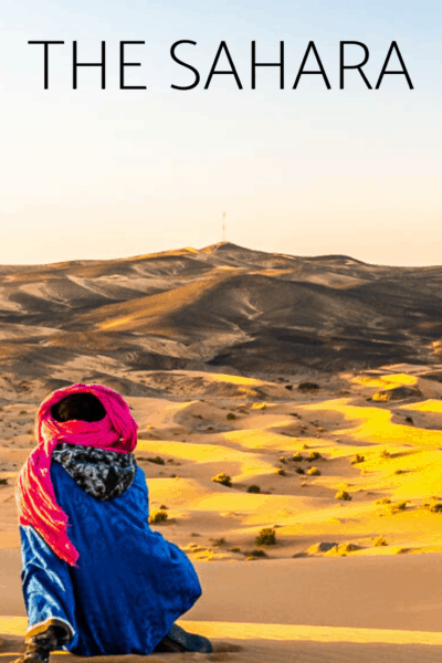 bedouin over looking the sahara desert at sunset