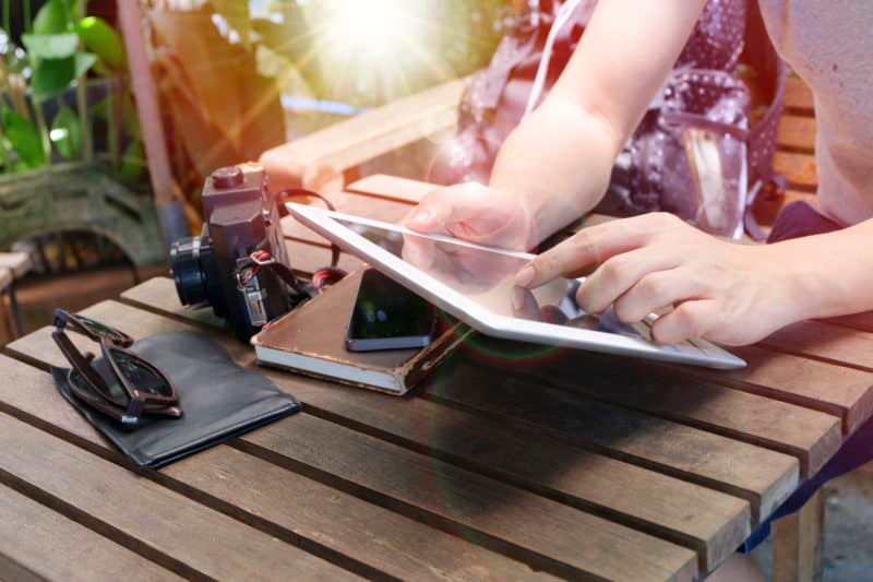 woman using her tablet for an alaska cruise online booking