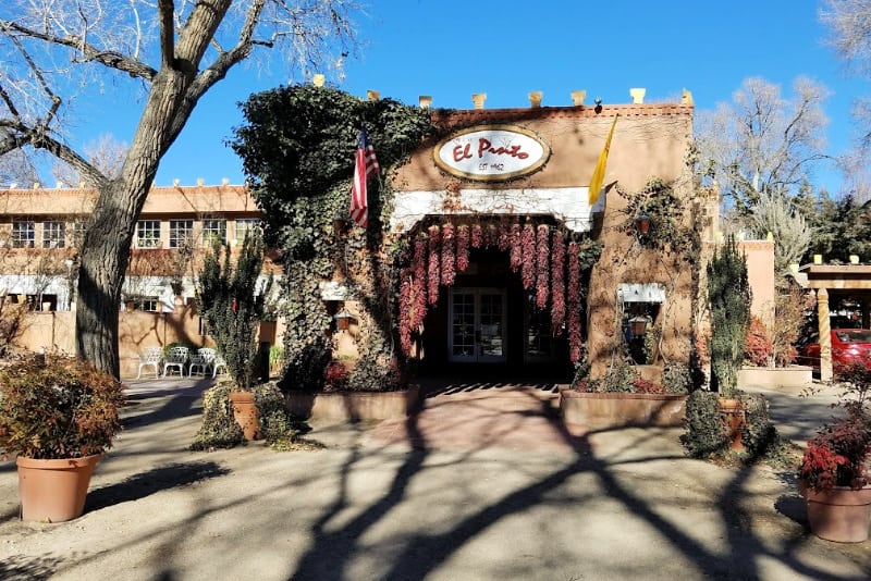 Front of El Pinto restaurant, decorated with ristras and greenery