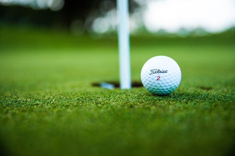 titleist golf ball next to the hole golfing in panama