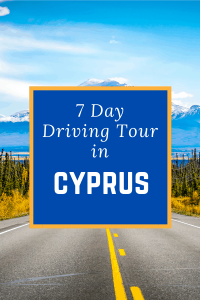 lines painted on road heading toward a mountain text says 7 day driving tour in cyprus