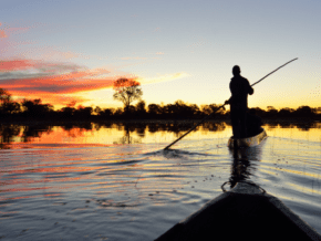 exploring Chobe river by local canoe at sunrise