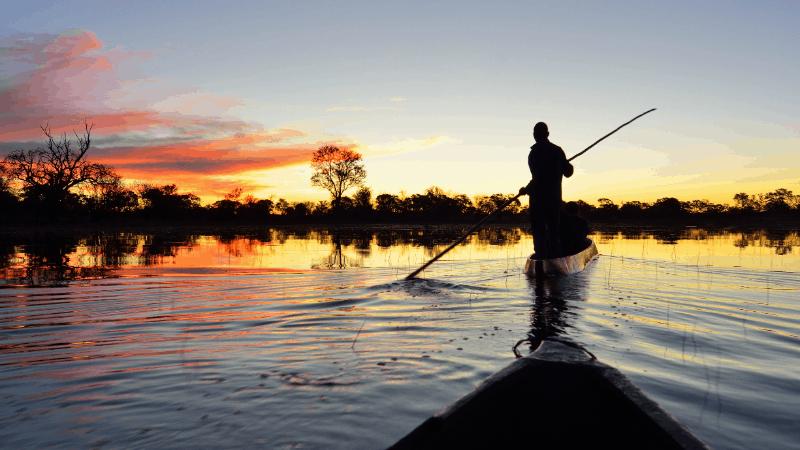 exploring Chobe river by local canoe at sunrise