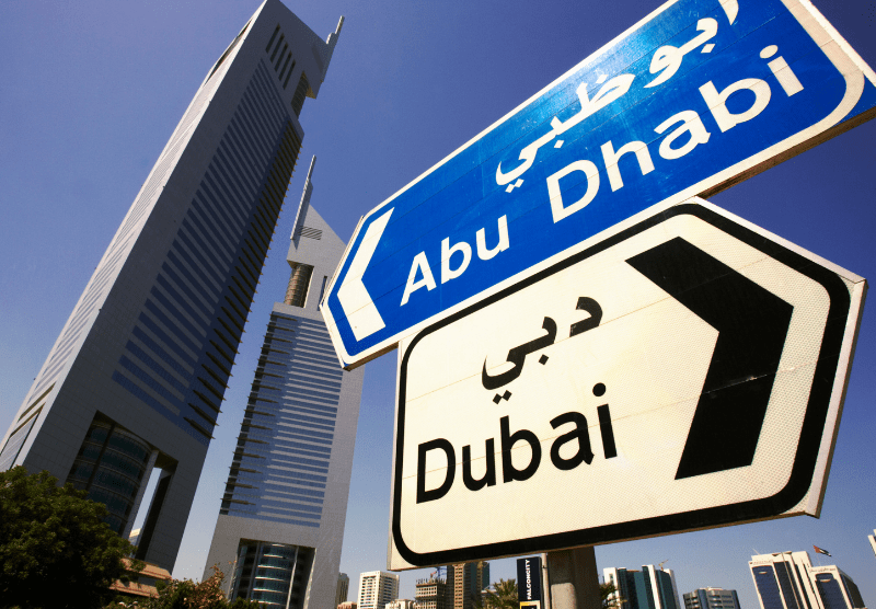 UAE street signs pointing to abu dhabi and dubai