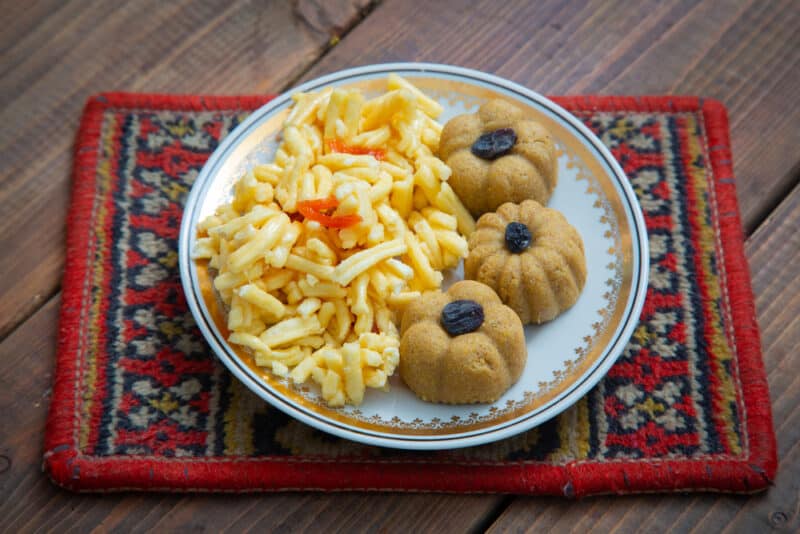 A plate of chak-chak and 3 raisin-topped zhent, traditional Kazan dishes