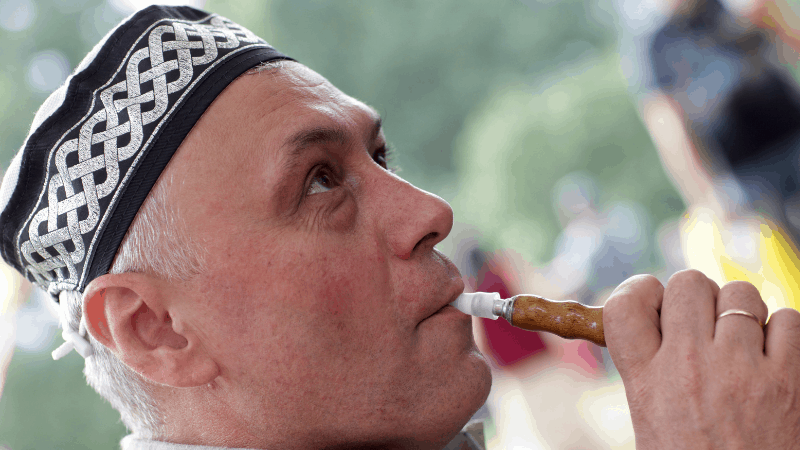 A man smoking a hookah and wearing a Tatar tubeteika. This hat makes a good souvenir of Kazan. 