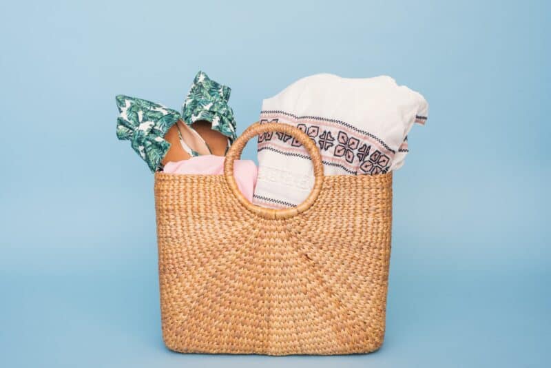 straw bag filled with things you'll want to bring on a Florida day trip