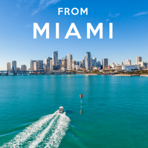 Miami cityscape with speedboat on the water heading toward the city. Maybe on one of the Miami day trips