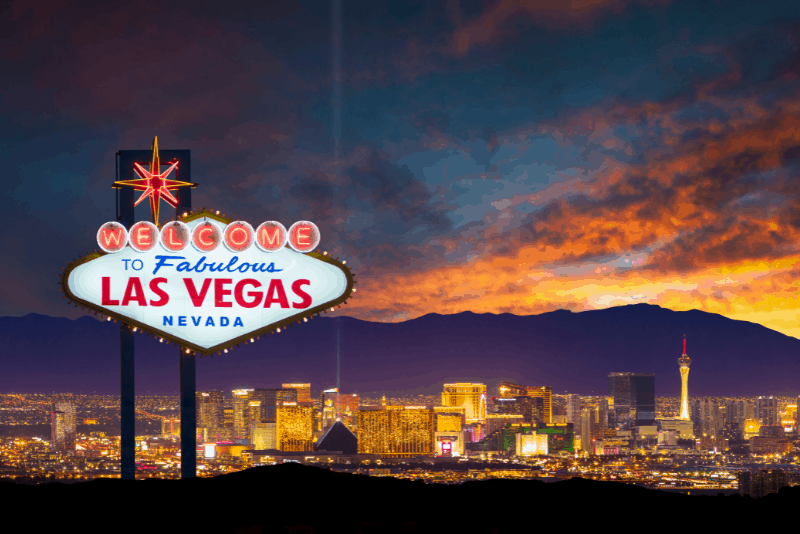 Sign says Welcome Fabulous Las Vegas Nevada, with cityscape in the background. Take some day trips from Las Vegas. Because there's more to Nevada than the Strip.