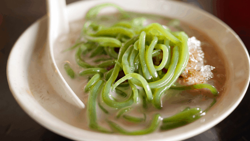 green ribbons of rice over cendol iced dessert